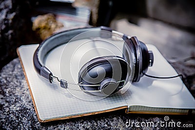 Playlist, notebook Headphones Stock Photo