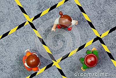 Playmobil character illustrating the marking on the ground and signage, for physical distance in the street or in the context of Editorial Stock Photo