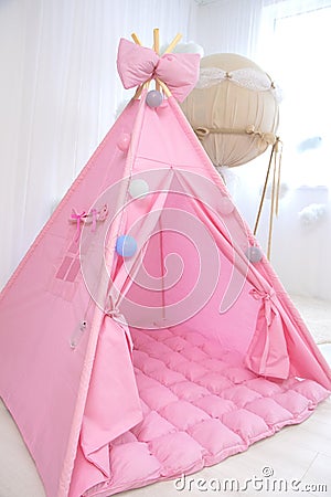 Playroom with Teepee. Modern room interior with play tent for child. pink wigwam Stock Photo