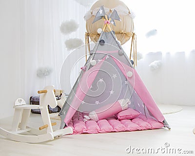 Playroom with Teepee. Modern room interior with play tent for child. pink wigwam Stock Photo