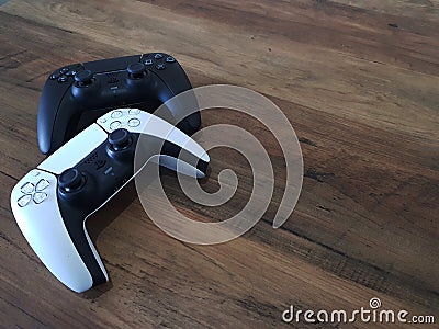 Playstation 5 Controller on wooden background with empty space for text. The concept of video games. Two gamepads Editorial Stock Photo