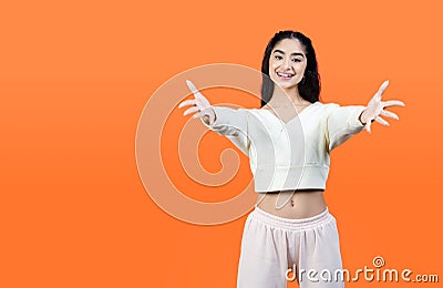 Pleasant attractive woman happy to meet you and stretches out two hands on us. Stock Photo