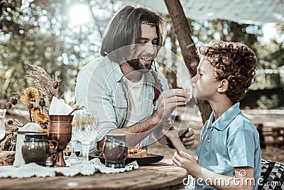 Pleasant bearded father washing his sons face Stock Photo