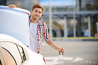 Pleasant boy opening boot Stock Photo