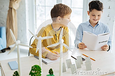 Pleasant boys doing their ecology home assignment Stock Photo