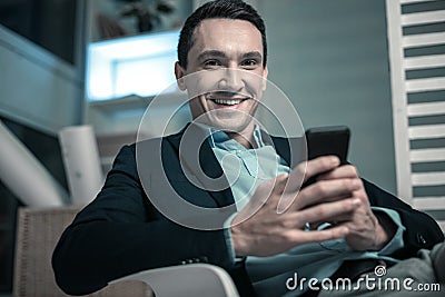 Pleasant business man texting a message on his phone Stock Photo