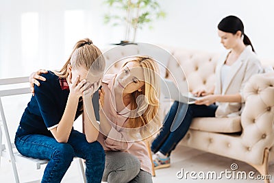 Pleasant caring mother worrying about her daughter Stock Photo