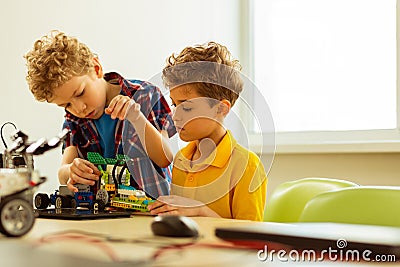 Pleasant cute boys working together during the class Stock Photo