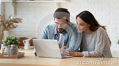 Happy young mixed race married spouse making purchases online. Stock Photo