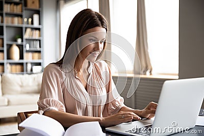 Pleasant happy young woman freelancer working on computer. Stock Photo