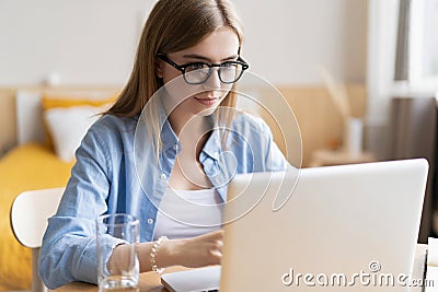 Working at home allow me for flexible working. Pleasant happy young woman freelancer working on computer at home. Stock Photo
