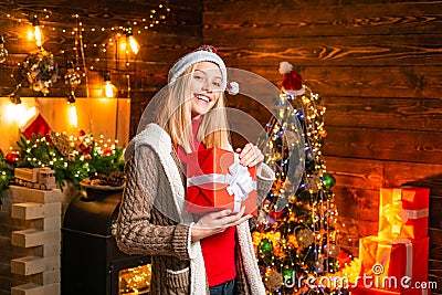 Pleasant moments. Christmas joy. Woman wooden interior christmas decorations garland lights. Christmas tree. Filled with Stock Photo