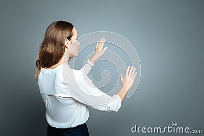 Pleasant nice woman touching invisible wall Stock Photo