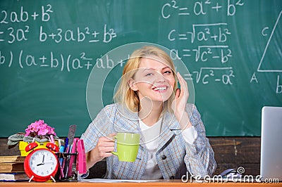 Pleasant relax after classes. Working conditions which prospective teachers must consider. Woman smiling teacher holds Stock Photo