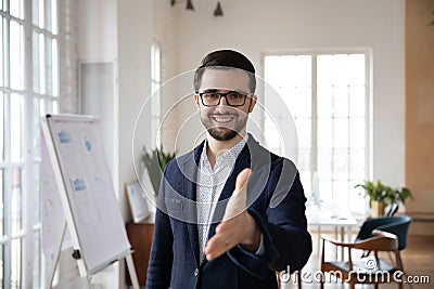 Pleasant smiling trustful manager in suit reaching out hand. Stock Photo