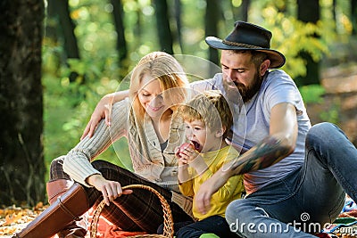 Pleasant time spending. Family picnic. Mother, cowboy father love their little boy child. Spring mood. Happy family day Stock Photo