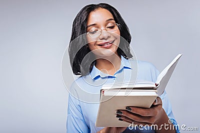 Pleasant woman reading notes in her notebook Stock Photo