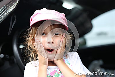 Pleasantly surprised excited child in the car Stock Photo