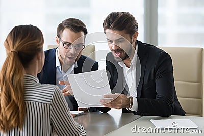 Pleasantly surprised hr managers reading resume of applicant. Stock Photo