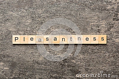 pleasantness word written on wood block. pleasantness text on cement table for your desing, concept Stock Photo