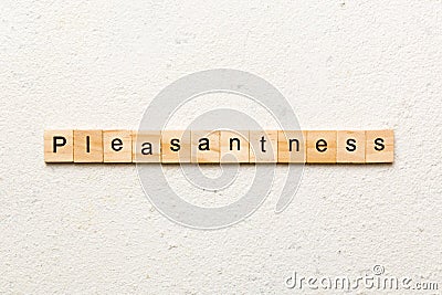 pleasantness word written on wood block. pleasantness text on cement table for your desing, concept Stock Photo