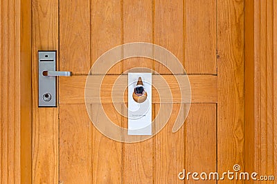 Please do not disturb sign on Closed wooden door of hotel room Stock Photo