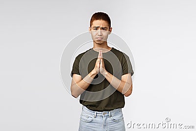Please help me out. Portrait of hopeful clingy cute asian man asking apology, clasp hands together in pray, gloomy Stock Photo