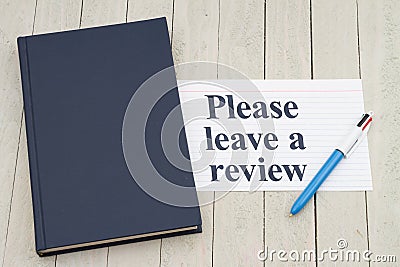 Please leave a book review with retro old blue book with index card and pen Stock Photo