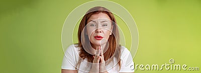 Please need help asap. Tender timid redhead middle-aged woman plead press palms together pray begging hopeful sincere Stock Photo