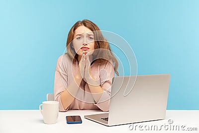 Please, need your help! Young woman employee sitting at workplace and holding hands in praying gesture, asking heartily Stock Photo