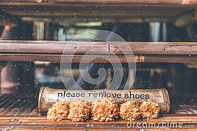 Please Remove shoes wooden sign plate. Stock Photo