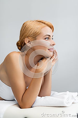 pleased blonde client lying on massage Stock Photo