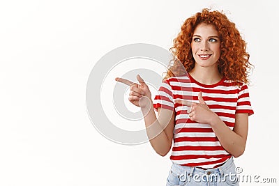 Pleased good-looking sassy flirty redhead stylish curly girl smiling delighted like what see pointing check out left Stock Photo