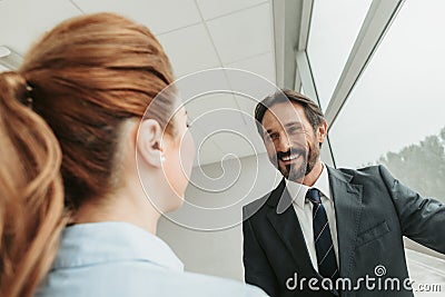 Pleased male speaking with girl during job Stock Photo