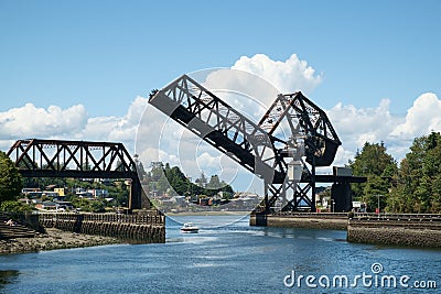 Pleasure boat below raised drawbridge Editorial Stock Photo