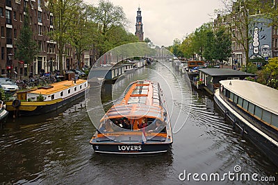 Pleasure boat on the Prinsengracht canal on a cloudy September day. Amsterdam, Netherlands Editorial Stock Photo