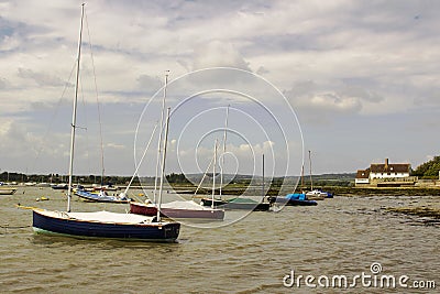 Pleasure boats on their moorings in the historic Bosham Harbour in West Sussex in the South of England Editorial Stock Photo