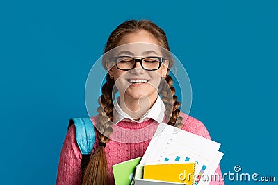 Pleasure of excellent test results. Girl with closed eyes holds notebooks and books Stock Photo