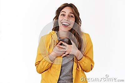 Pleasure meet you. Delighted touched young tender pretty girl press hands heart sighing gladly smiling toothy appreciate Stock Photo