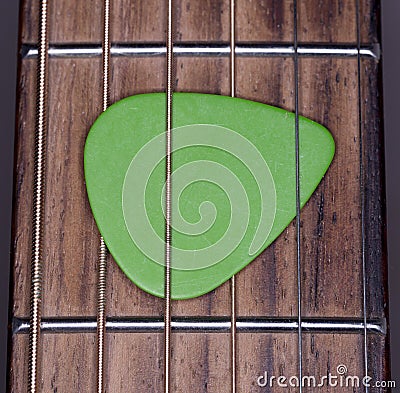 Plectrum Stuck in Steel Strings Stock Photo