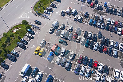 Plenty of cars in the packed parking lot in straight rows from a bird`s-eye view Stock Photo