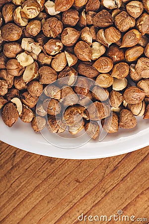 Plenty of ripe hazelnuts on plate Stock Photo