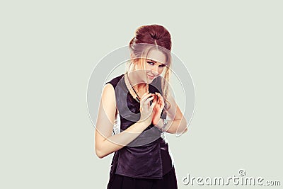 Plotting. Closeup portrait of sneaky, sly, scheming young woman plotting something isolated on light green gray background. Stock Photo