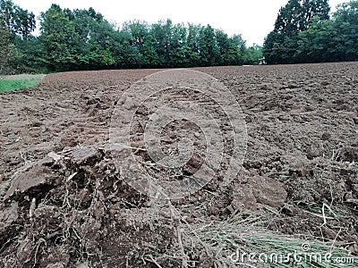 Ploughed soil in farmlands landscape in italy Stock Photo