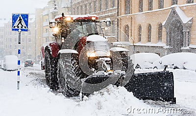 Plow removing snow from city street in Stockholm Editorial Stock Photo