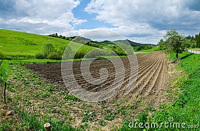 Plowed agricultural field. Tillage field et farm in sunny day. Stock Photo