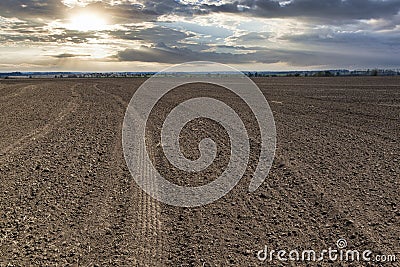 Plowed farm field at the sunset Stock Photo