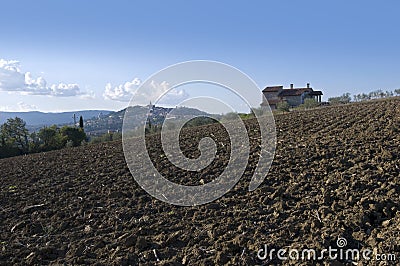 Plowed land with country house Stock Photo