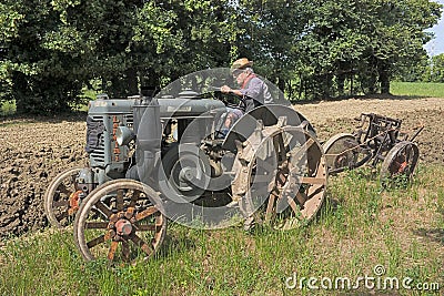Plowing with old tractor Editorial Stock Photo