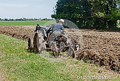 Plowing with an old tractor Editorial Stock Photo